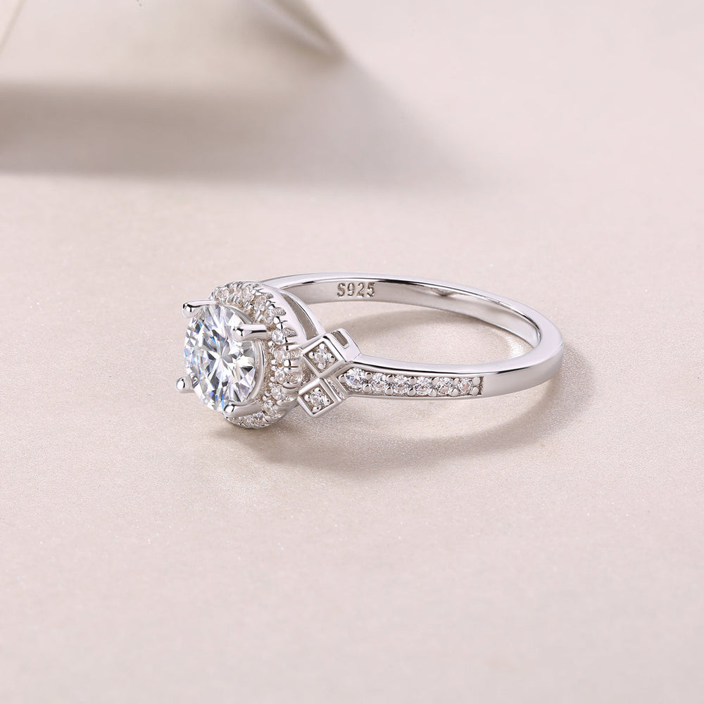 Side view of round halo art deco cross pavé ring with “925” marking on band
