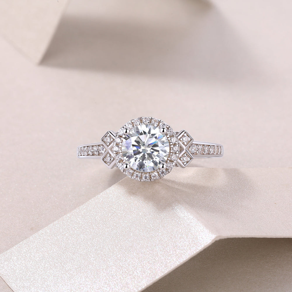 Round halo art deco cross pavé ring with round center stone and cross-shaped side stones