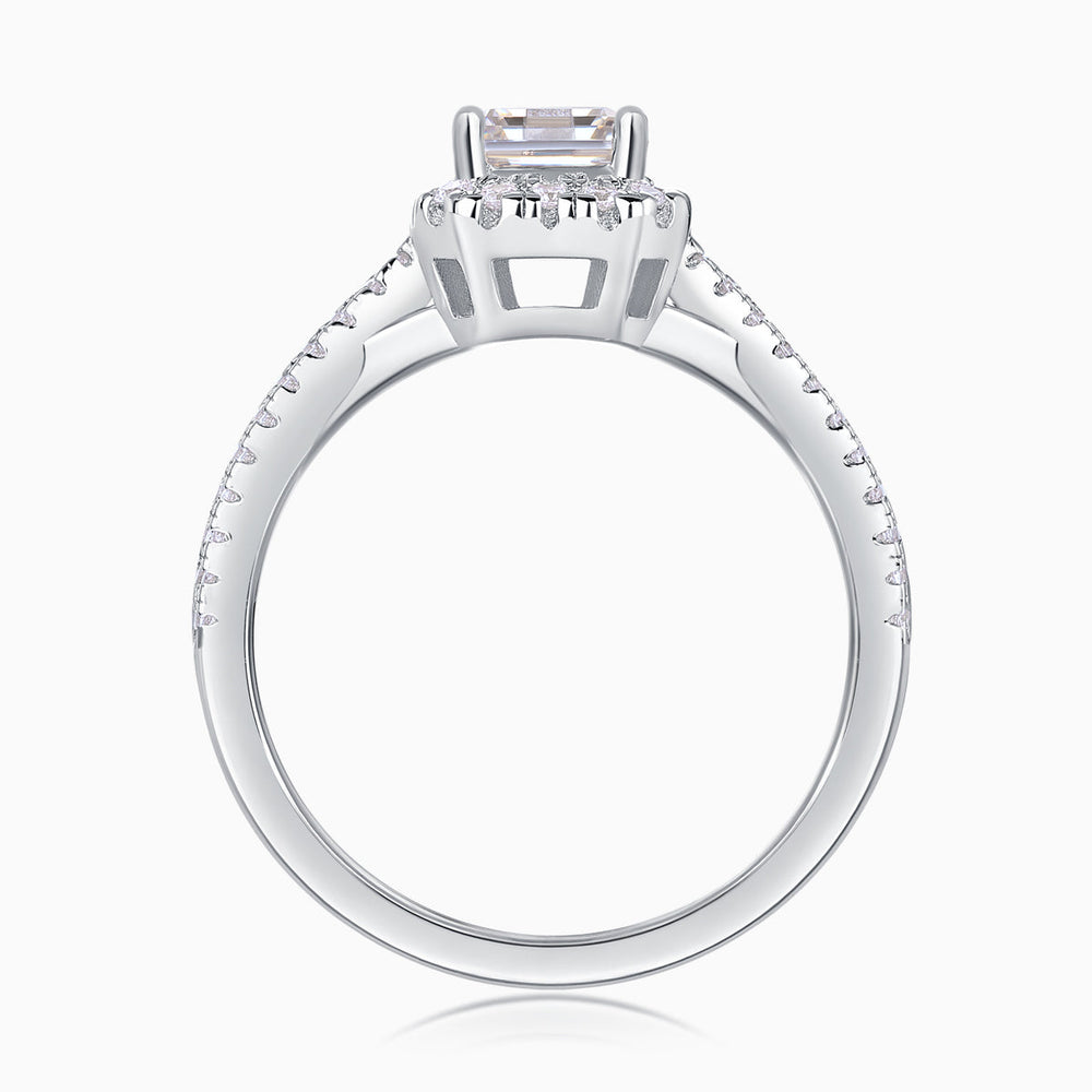 Underside view of emerald-cut halo ring with twisted pavé shank, white metal