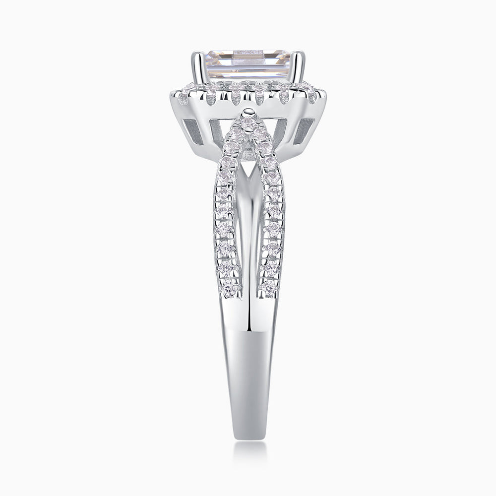 Front view of emerald-cut halo moissanite ring with twisted pavé side stones, white metal