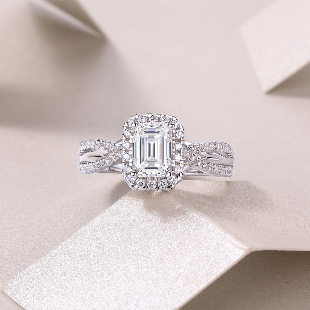 Emerald-cut halo moissanite ring with twisted pavé shank, white gold tone on finger