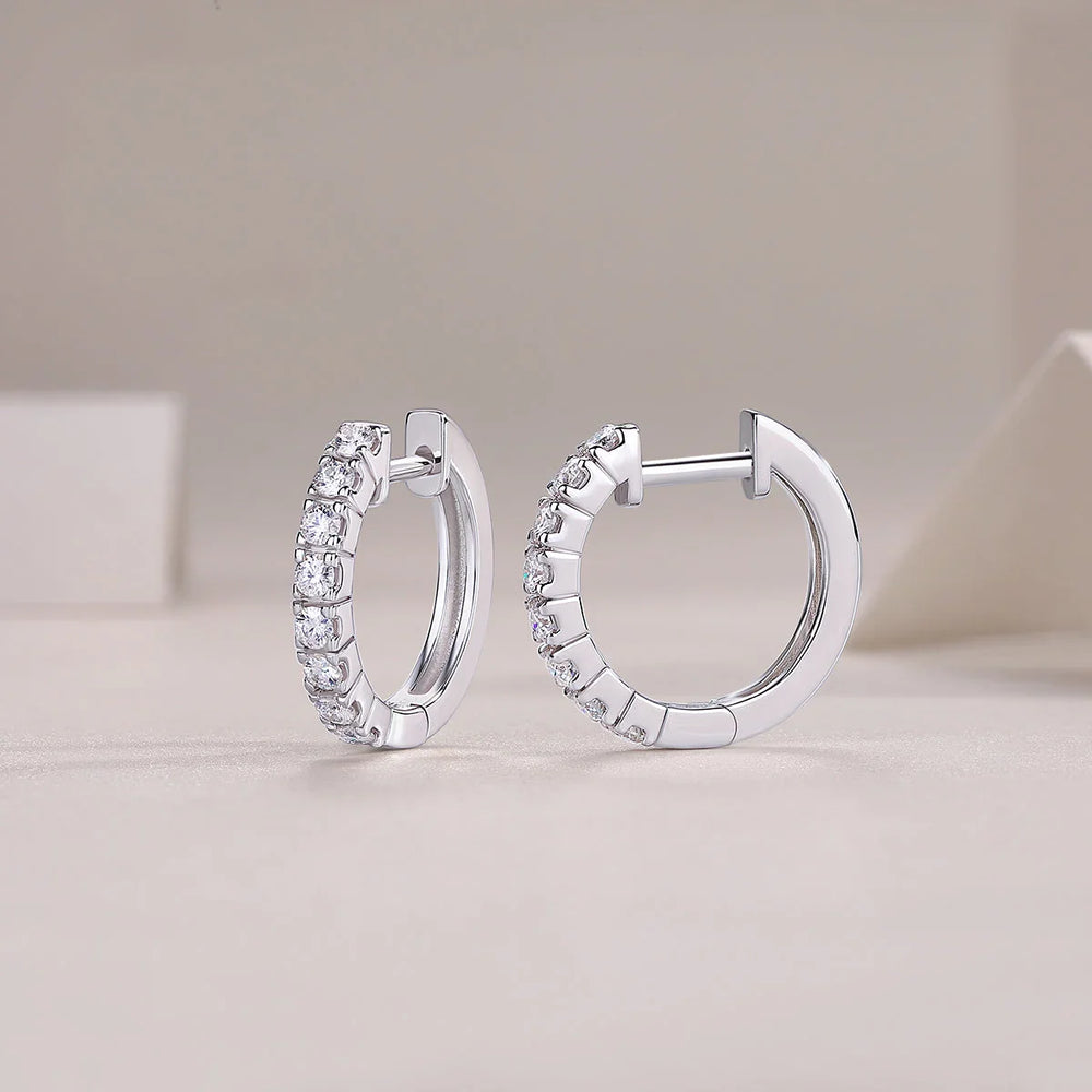 Moissanite huggie hoop earrings in shared prong setting, side view with hinge post