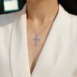 White gold vermeil pavé cross pendant on a chain, close view at neckline