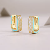 Back view of triple-row square pavé huggie earrings; yellow gold vermeil with blue inner trim