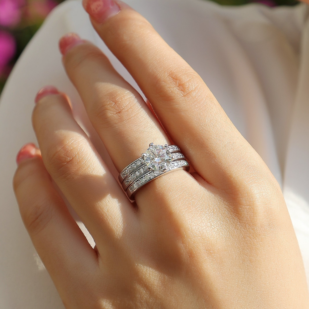 Stackable rings with round center moissanite and two pavé bands, worn together