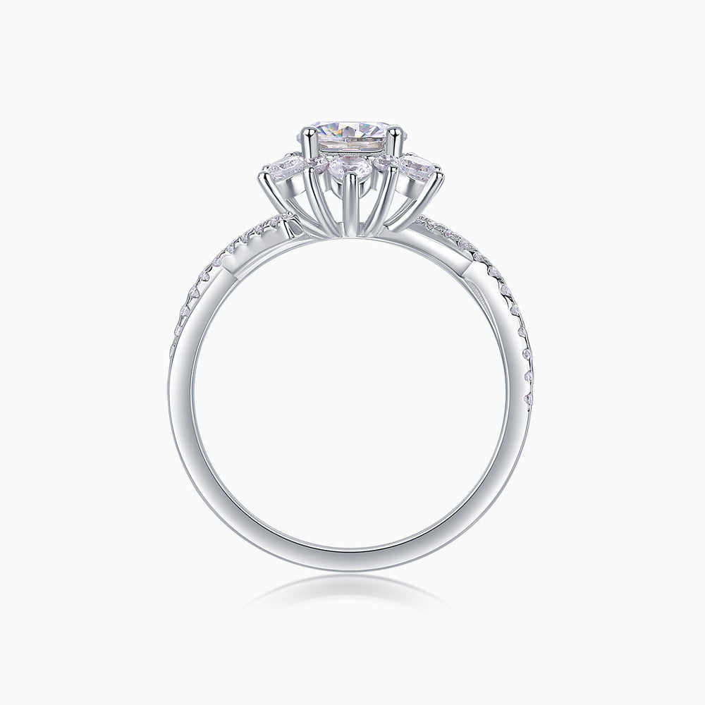 Top view of round halo engagement ring with cathedral prongs and pavé shank