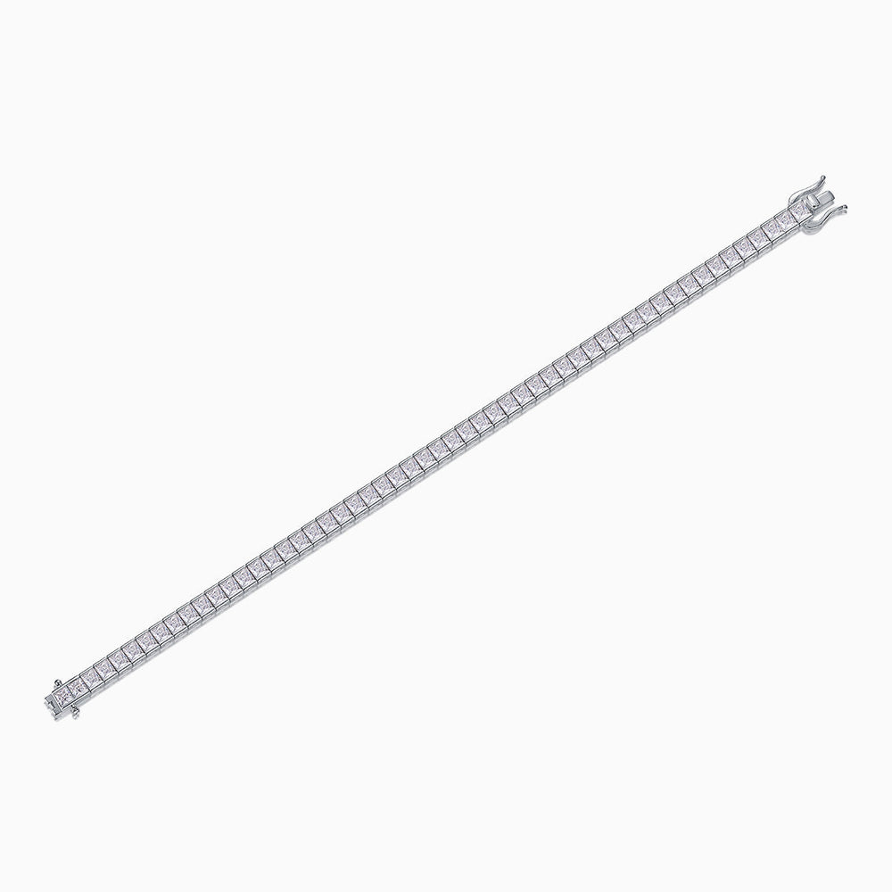 Princess cut moissanite tennis bracelet laid flat, silver-toned with square stone line