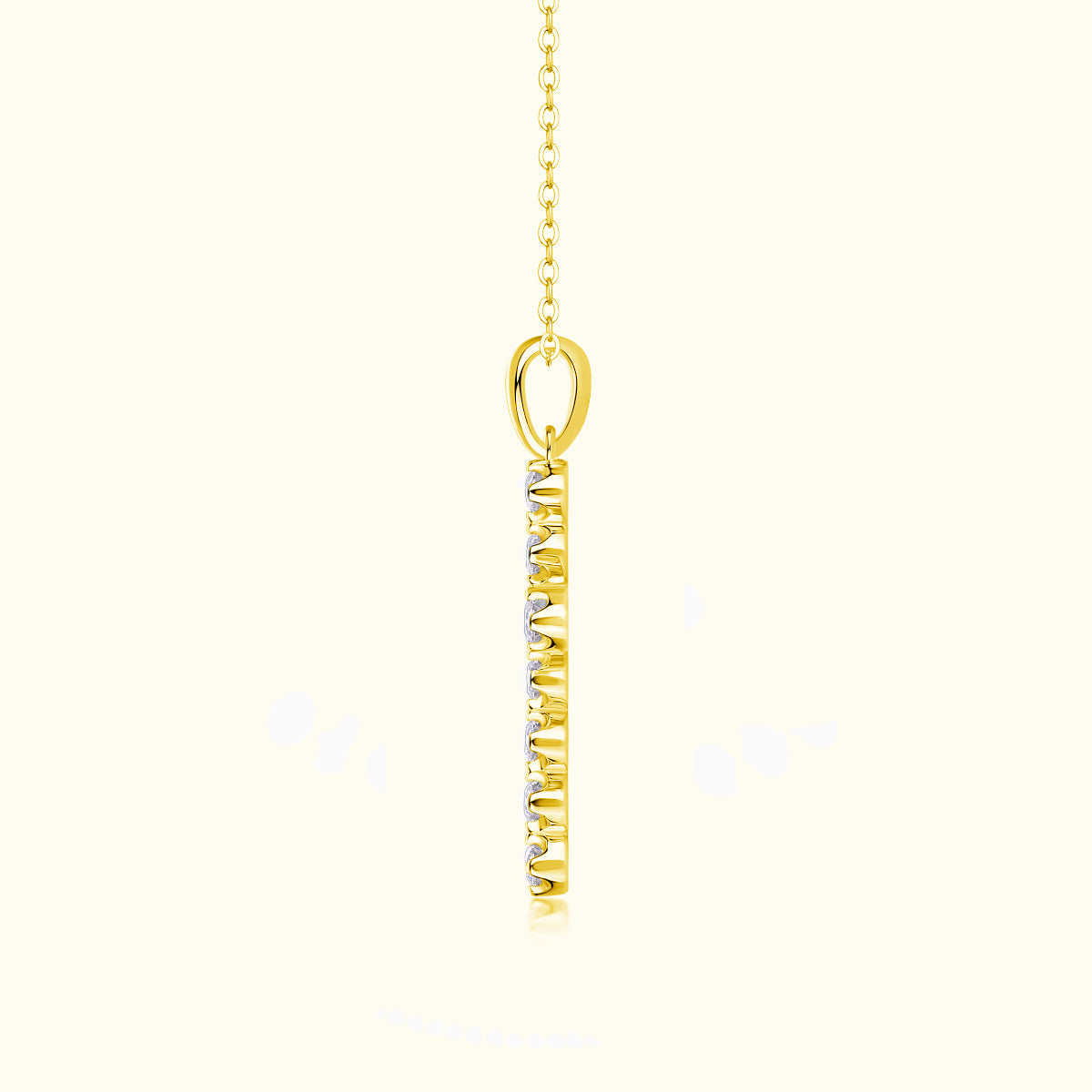 Yellow gold cross pendant on link chain, oval bail and stone-set front
