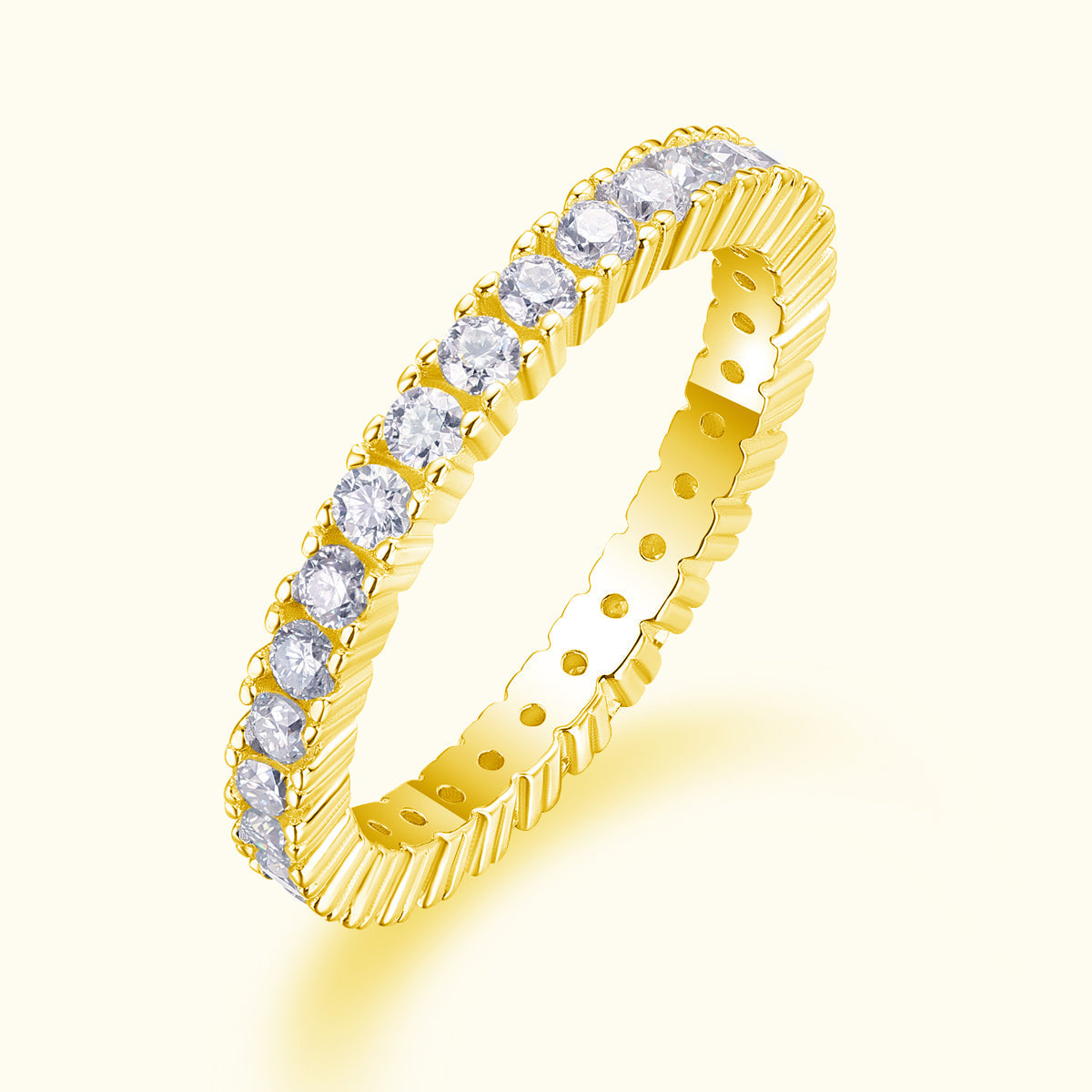 Yellow gold tone moissanite pavé stacking ring, angled view showing round stones along band
