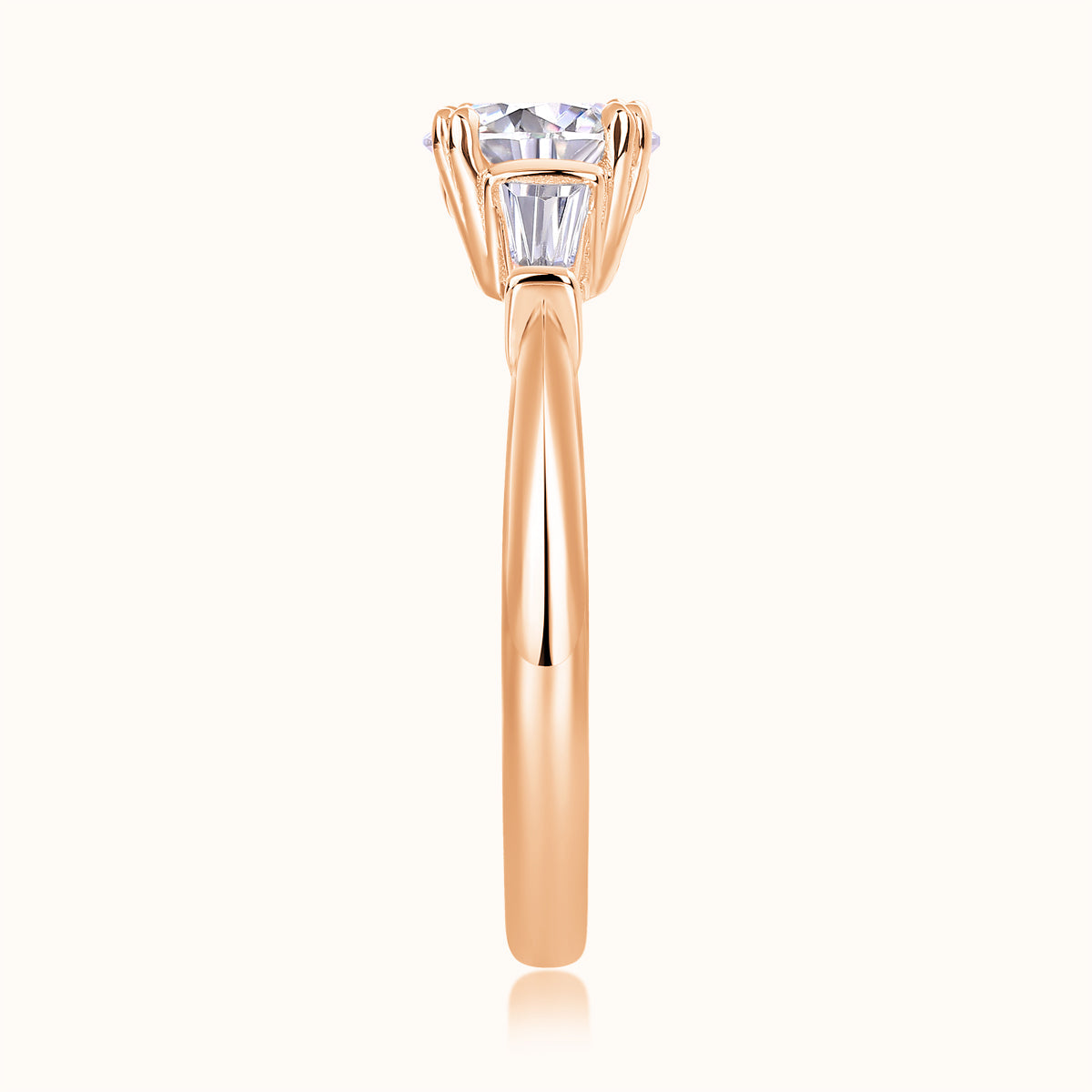 Three-stone ring with center round moissanite, rose gold vermeil prongs