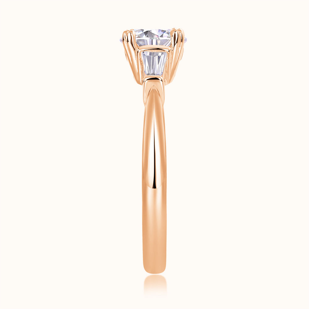 Three-stone ring with center round moissanite, rose gold vermeil prongs