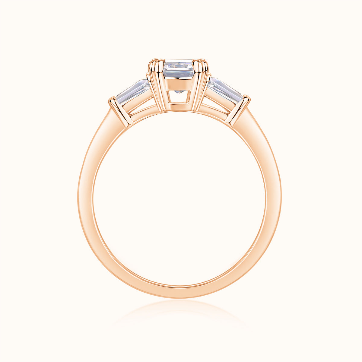 Rose gold vermeil three-stone emerald-cut moissanite ring, top view of prong setting