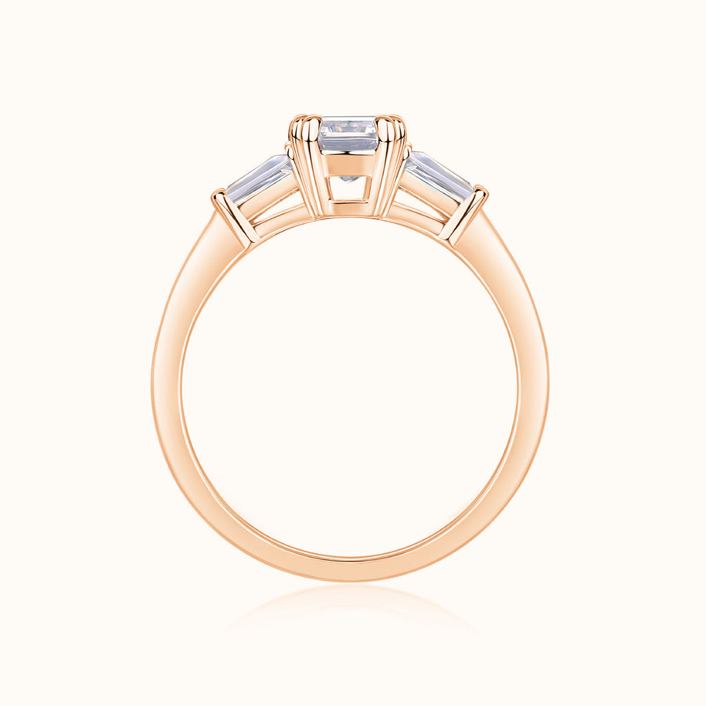 Rose gold vermeil three-stone emerald-cut moissanite ring, top view of prong setting