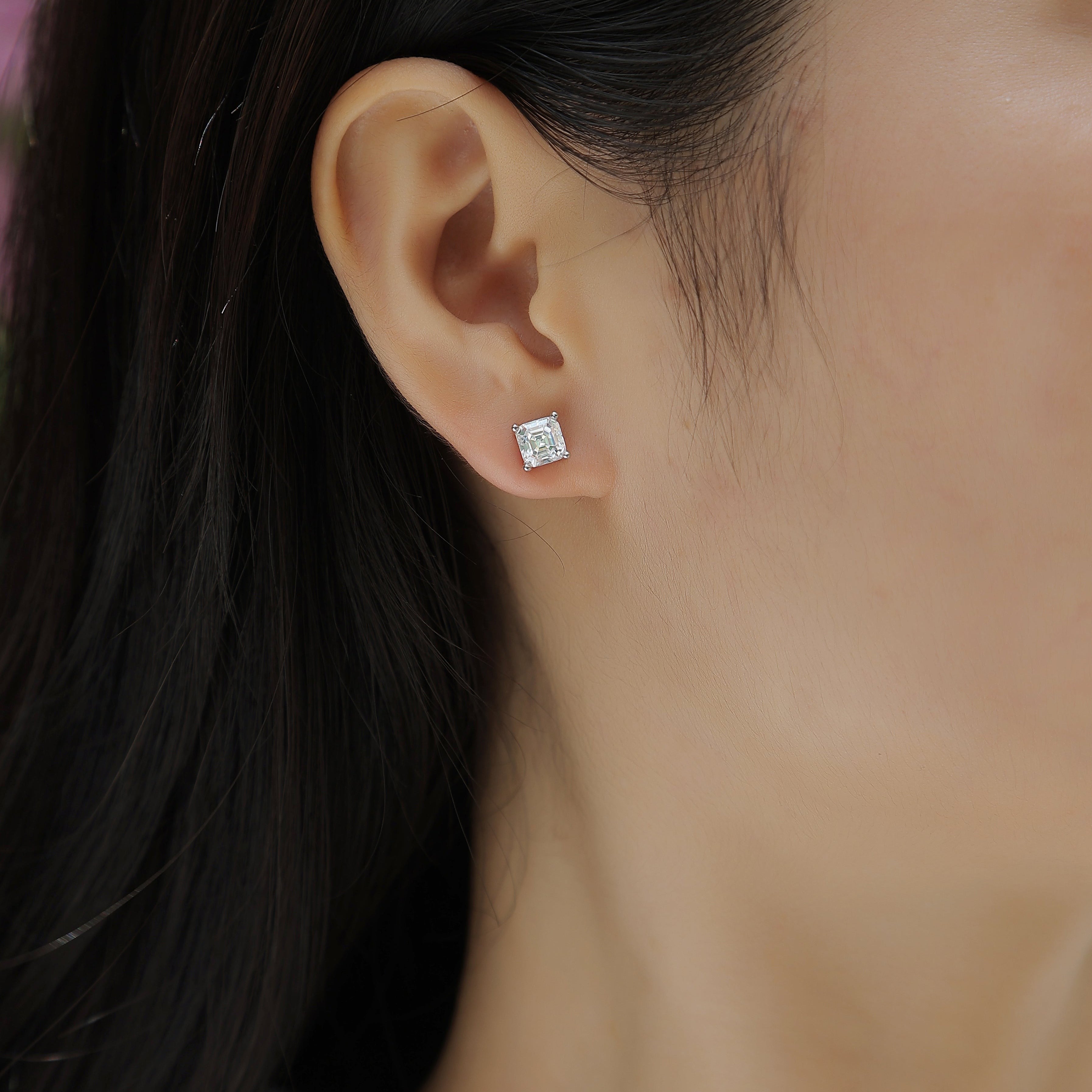 Asscher-cut moissanite stud earring on ear, white stone in white gold vermeil