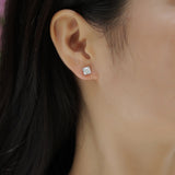 Asscher-cut moissanite stud earring on ear, white stone in white gold vermeil