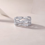 Wide crossover band ring with round moissanite stones and pavé accents, side view