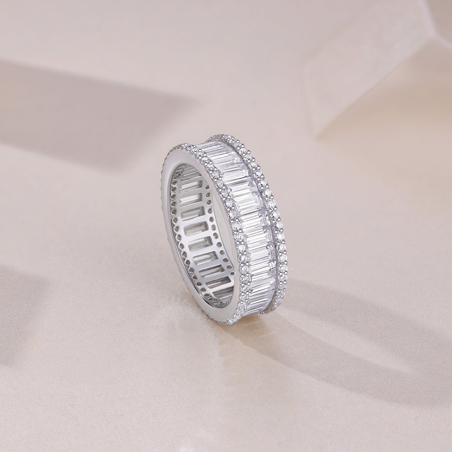 Cylen emerald-cut eternity band side view with rectangular stones, pavé border