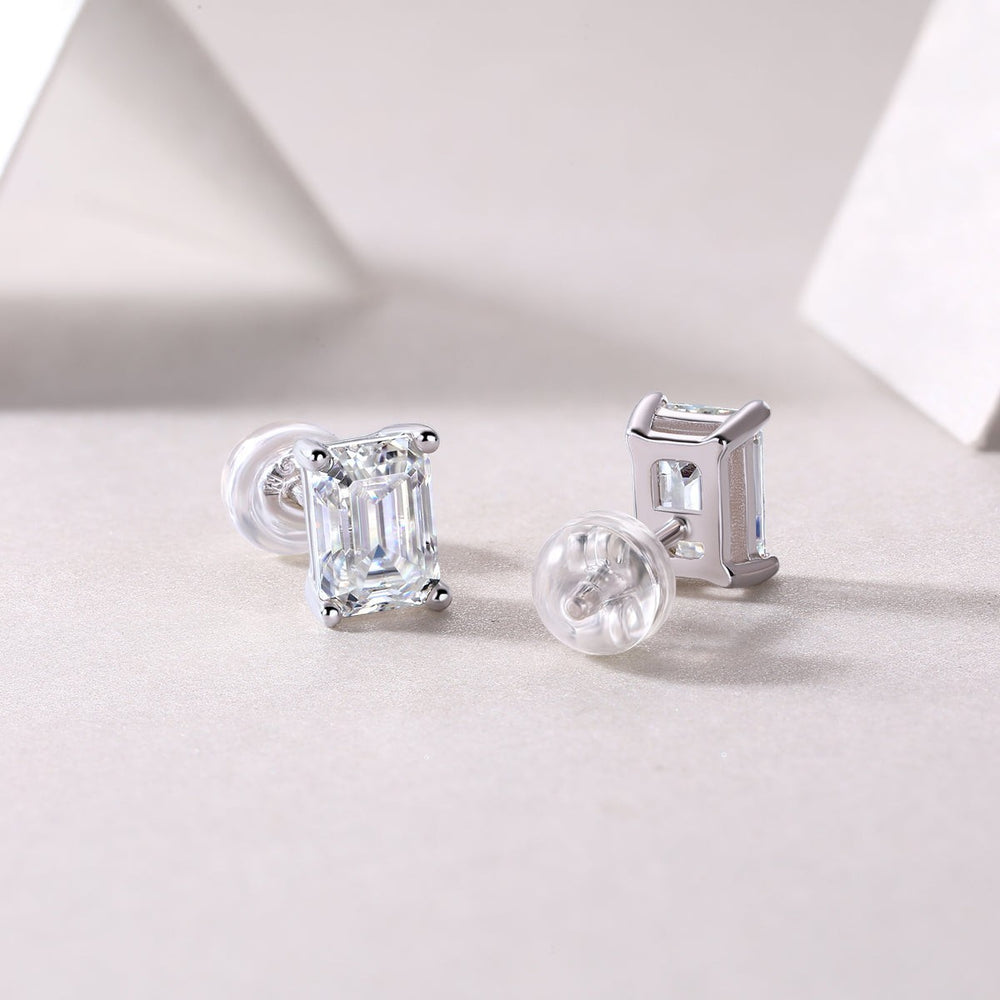 Emerald cut moissanite studs, side view; clear stone in white gold vermeil