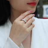 Five-stone moissanite ring on hand, white gold vermeil, five round stones