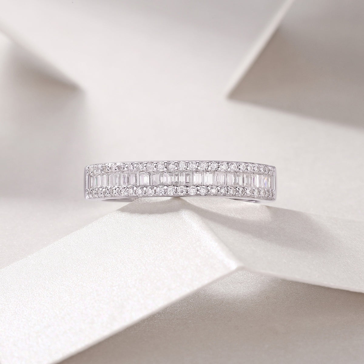 Moissanite half-row stacking band ring, white gold vermeil, angled view of paved top