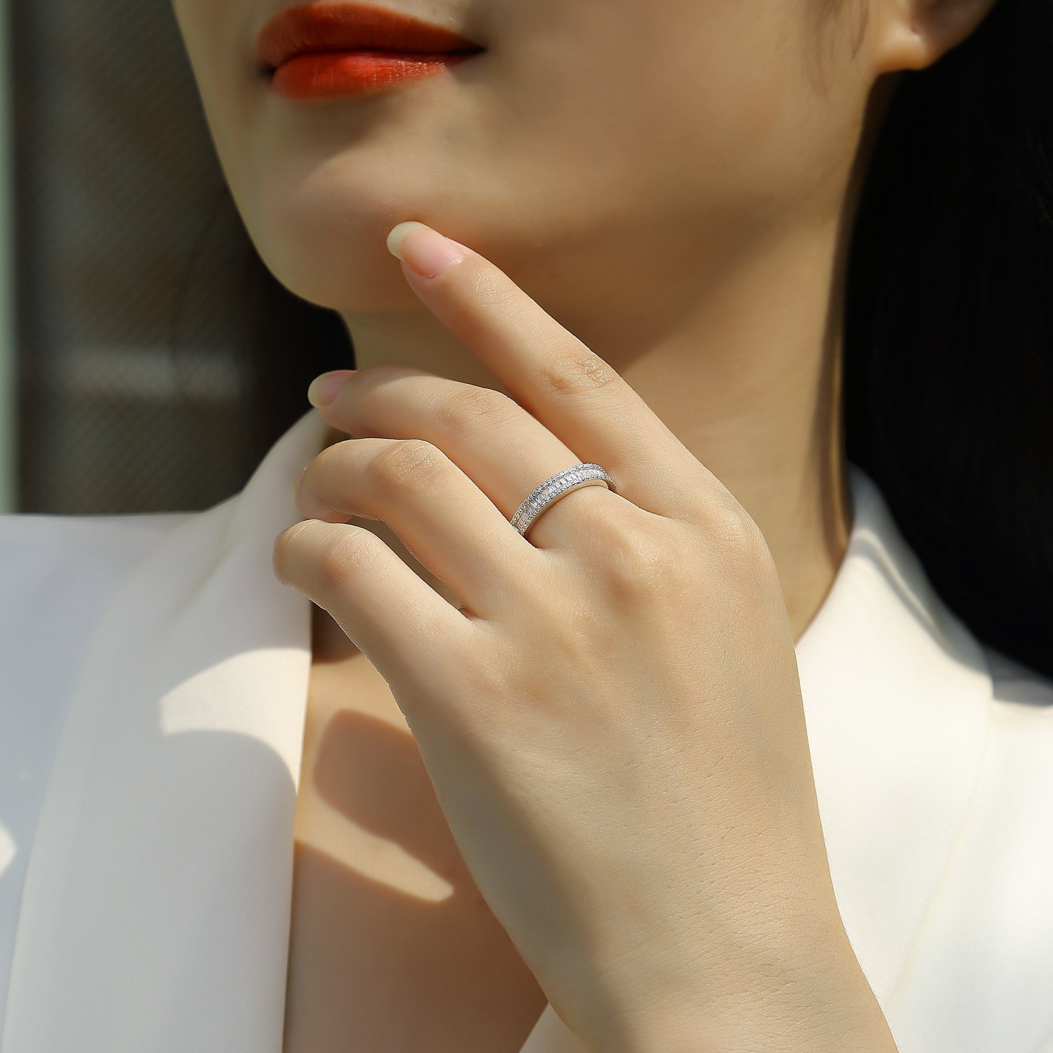 Moissanite half-row stacking band ring in white gold vermeil on finger
