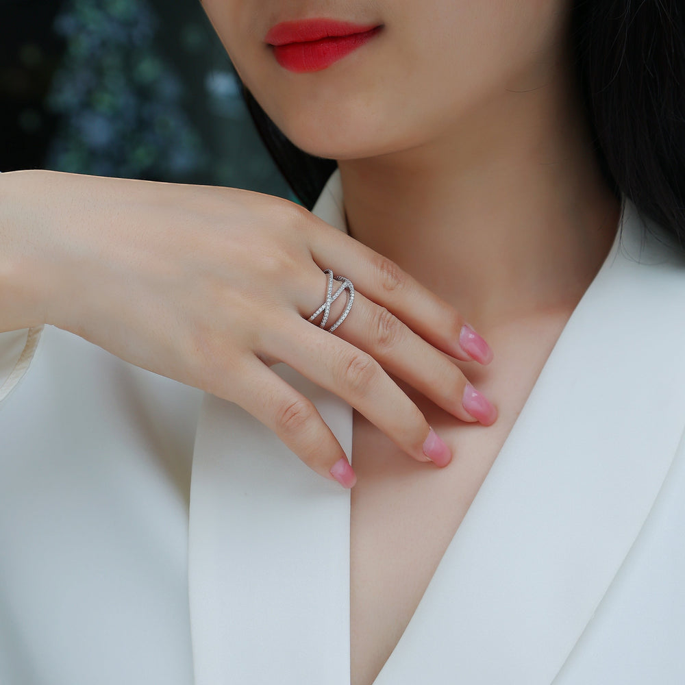 Wide band criss-cross moissanite ring with pavé sparkle on finger
