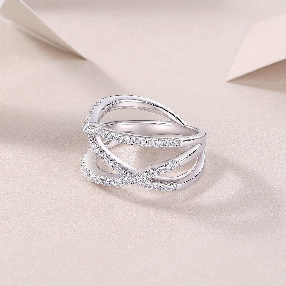 Criss-cross moissanite ring, openwork heart-like bands with pavé edges