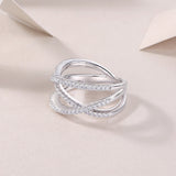 Criss-cross moissanite ring, openwork heart-like bands with pavé edges