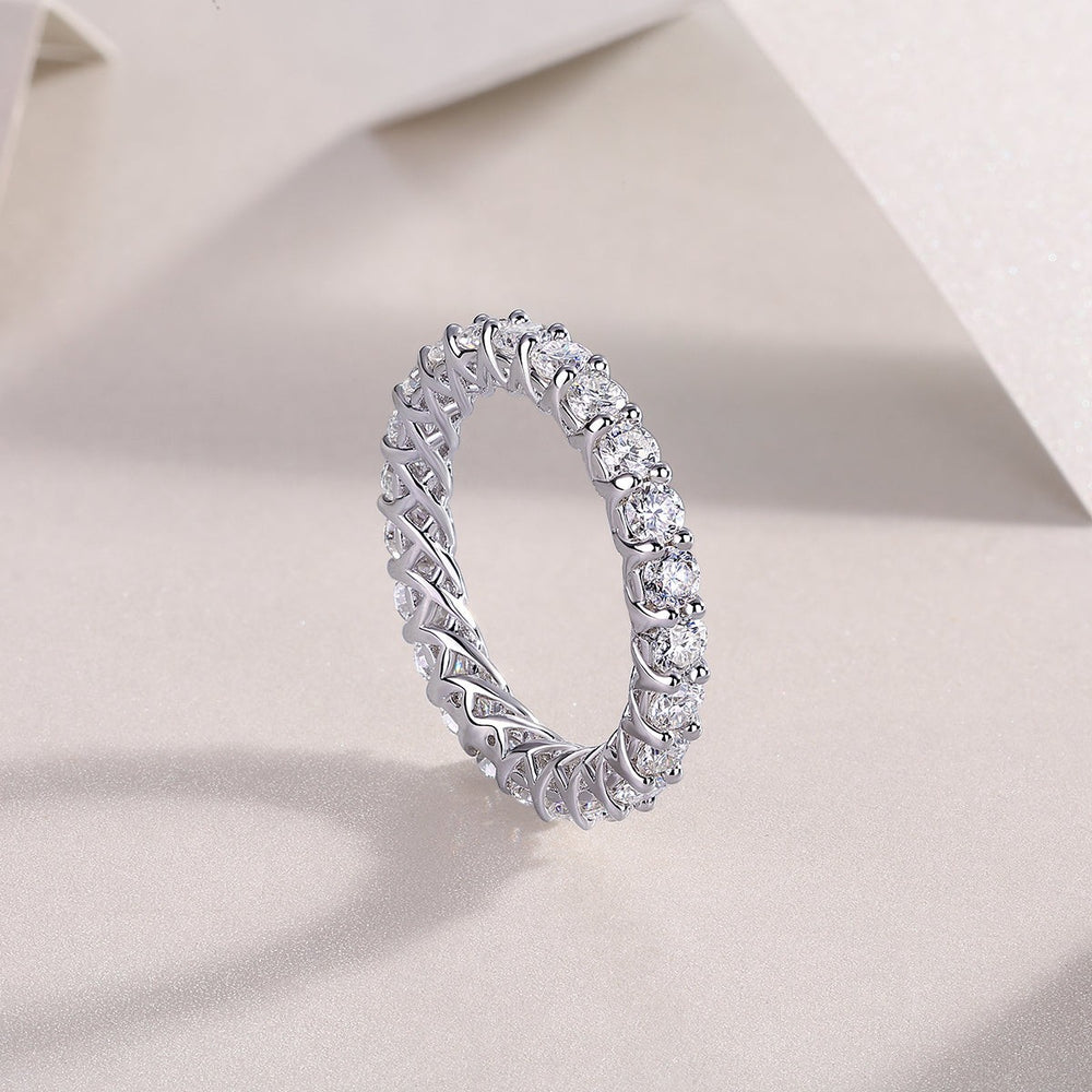 Moissanite eternity band with round stones and sculpted basket settings, white gold vermeil