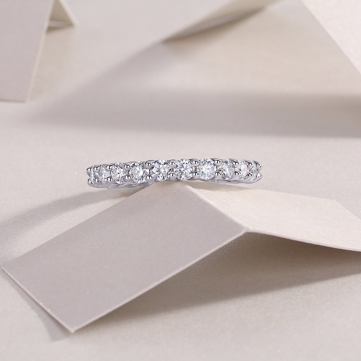 White gold vermeil pavé eternity band with evenly spaced round moissanite stones
