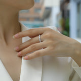 Moissanite eternity band ring (white gold vermeil) on hand, round stones