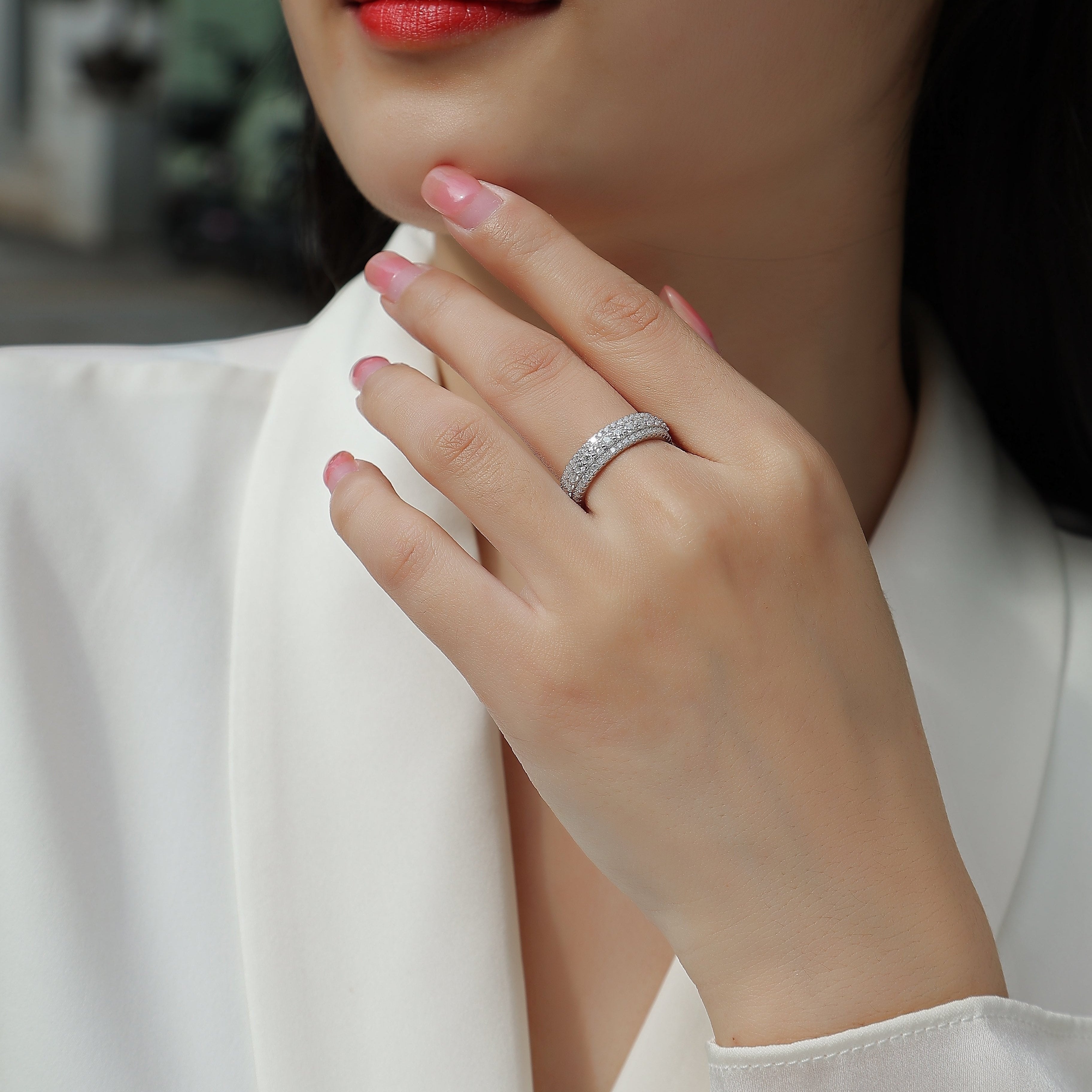 Moissanite pavé eternity band ring on hand, continuous sparkling stone row