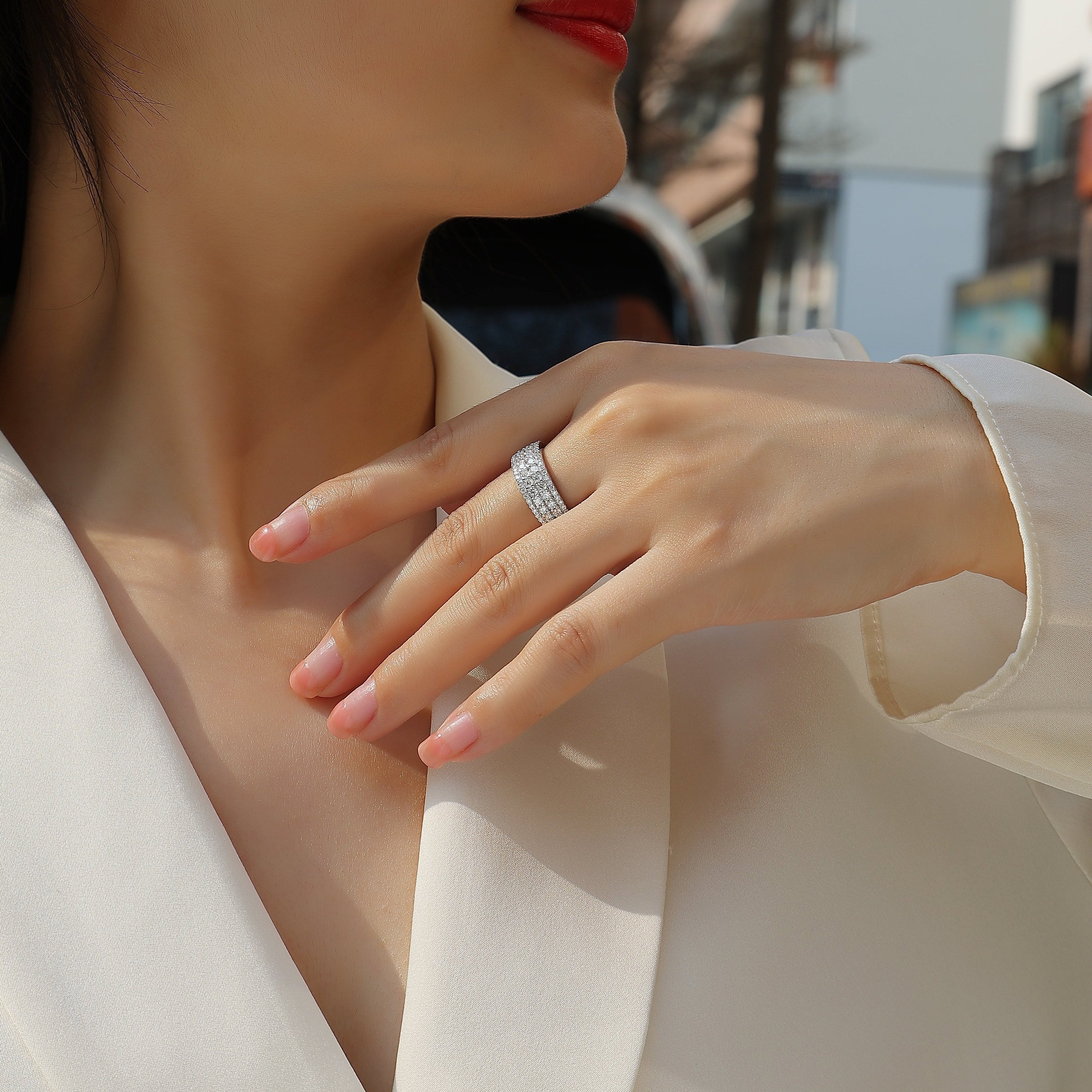 Four-row pavé moissanite eternity band on finger, white gold vermeil, close-up
