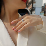 Four-row pavé moissanite eternity band on finger, white gold vermeil, close-up