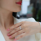 Moissanite eternity band on finger, slim profile with evenly set round stones
