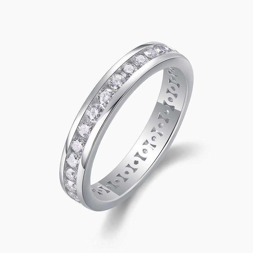 Moissanite eternity band with polished interior and pave row of round stones