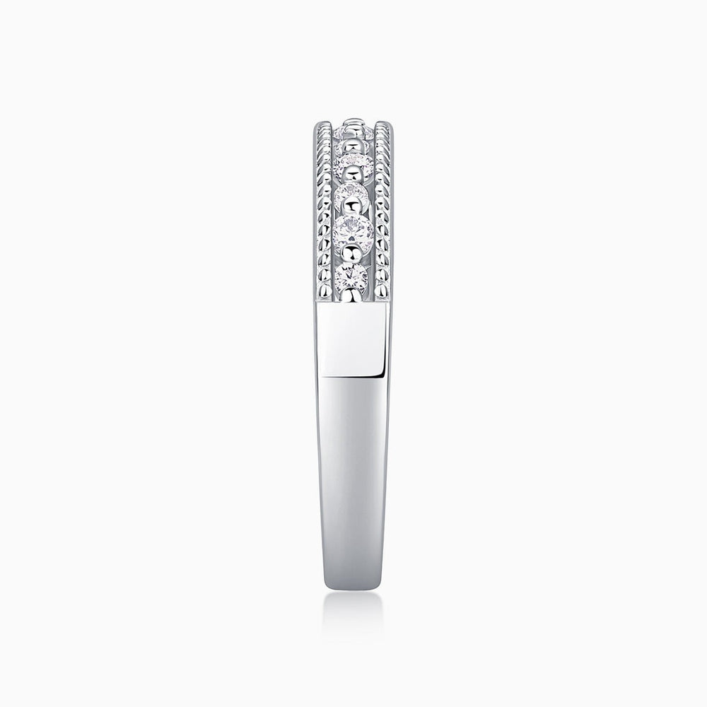 Moissanite half pavé ring side view with raised round-stone setting
