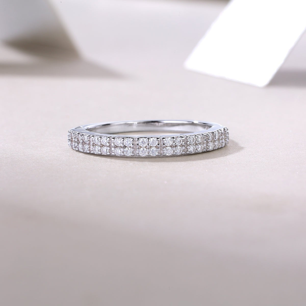 White gold vermeil half eternity band, continuous pavé row of round stones