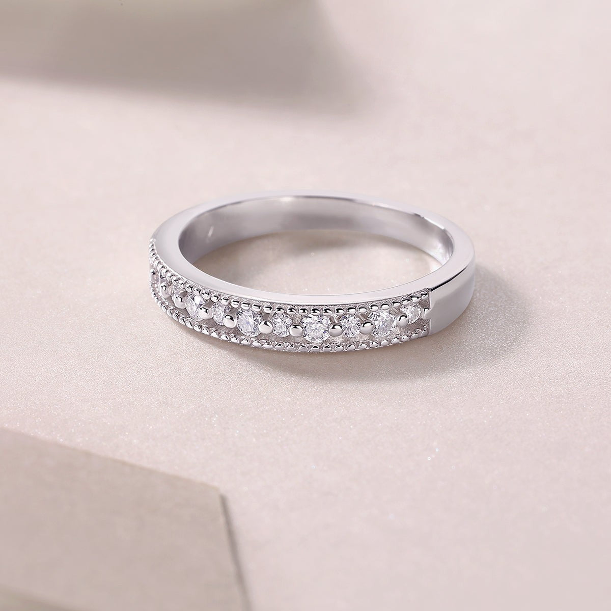 Moissanite half pavé eternity ring in white gold vermeil with round stones