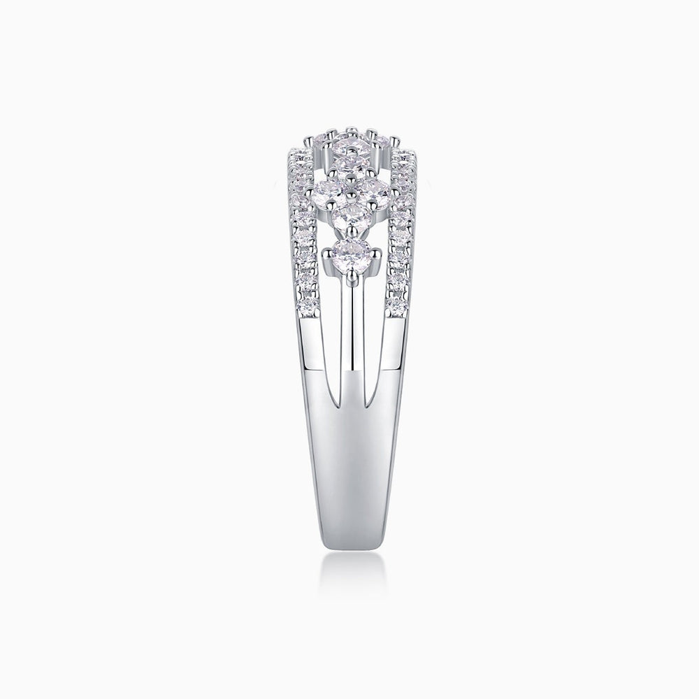 Moissanite half-row wedding band profile showing bezel settings and pavé side stones