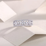 Moissanite half-row wedding band with central sparkle stones and pavé stone surround