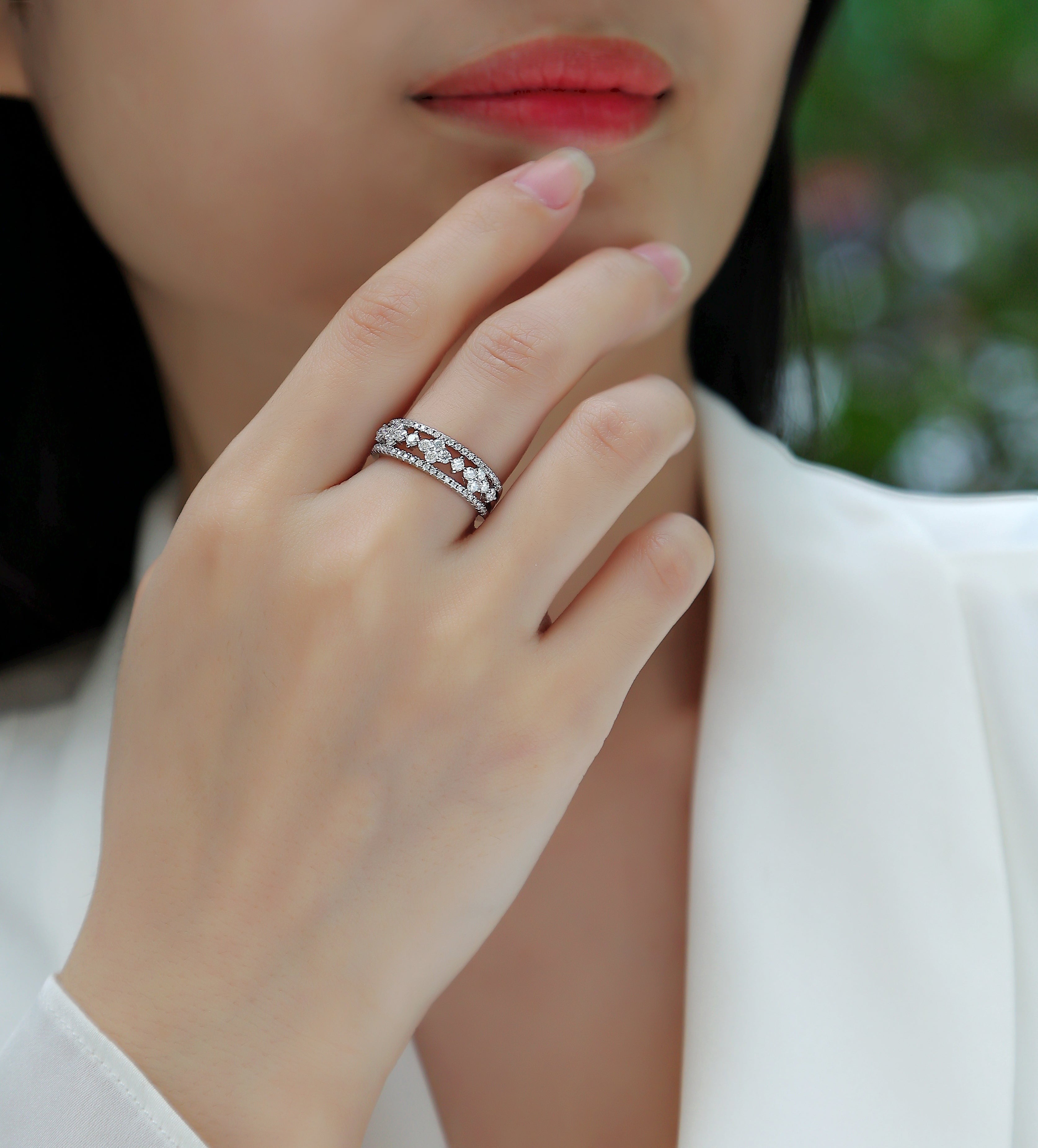 White gold vermeil half-row moissanite wedding band on finger with bright pavé accents