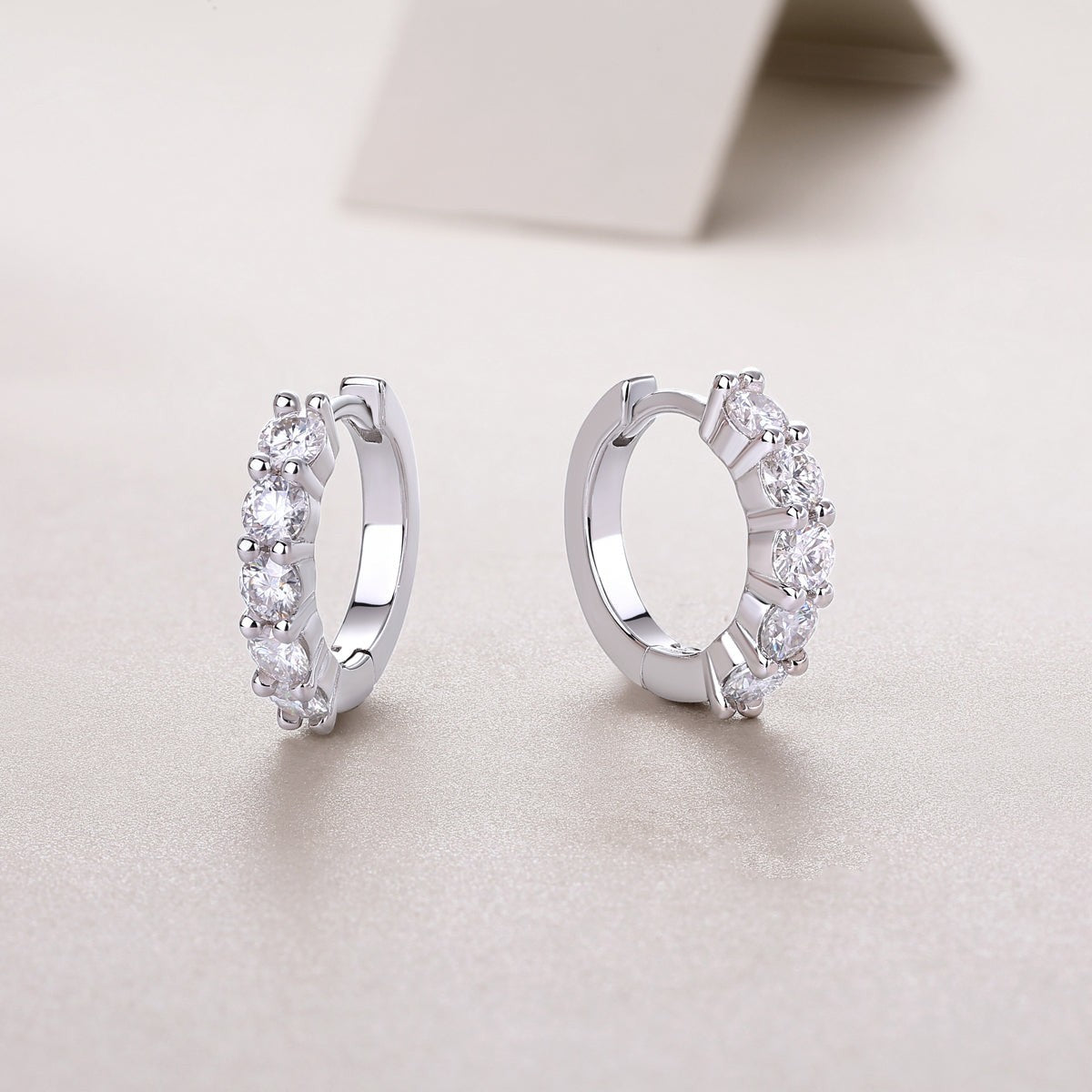 Open round hoop earrings with bezel-set moissanite stones, white gold vermeil