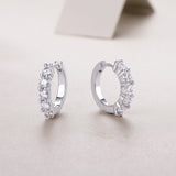 Open round hoop earrings with bezel-set moissanite stones, white gold vermeil