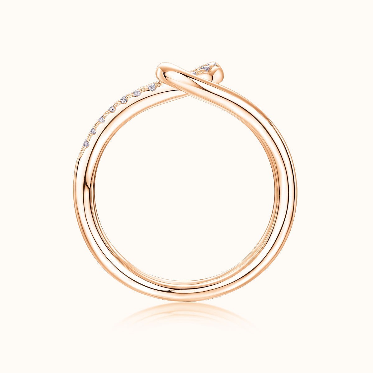 Rose gold tone wide band ring, smooth back profile with pavé on top edge