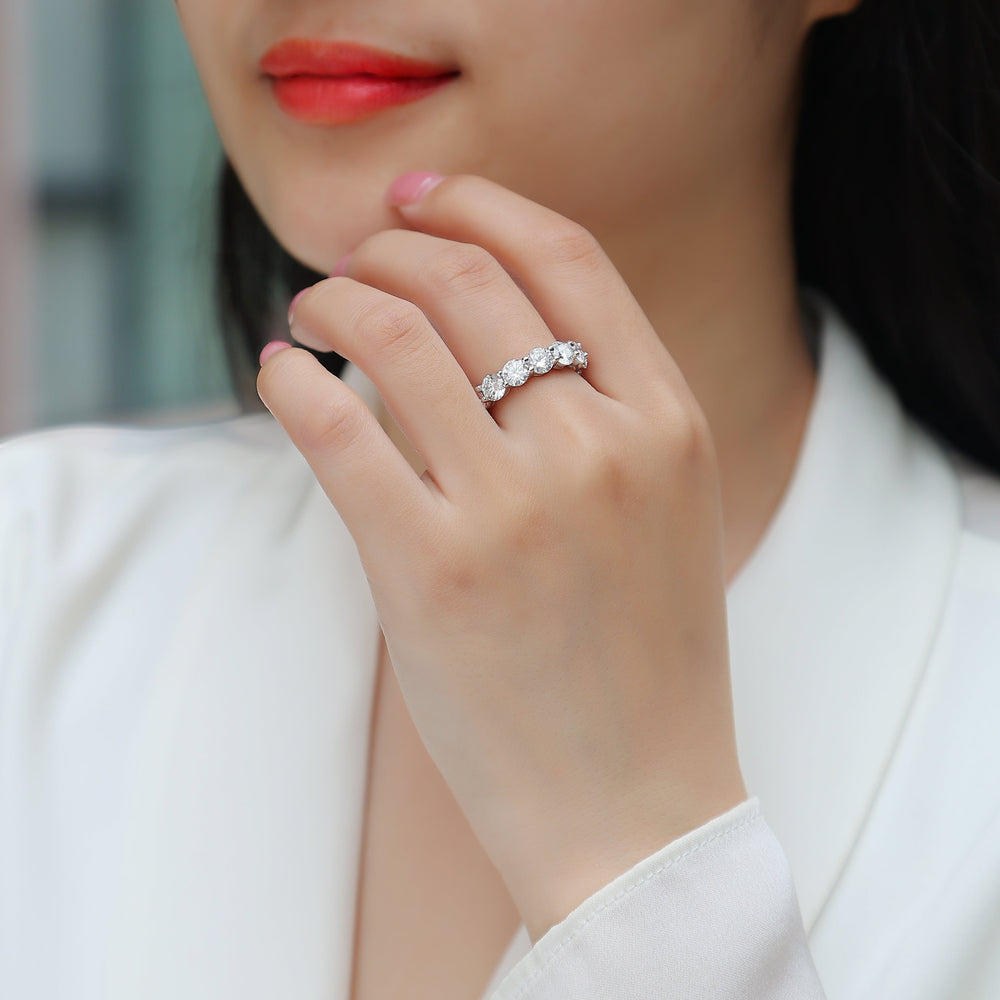 Round Moissanite Pavé wedding band on hand, white-gold vermeil, round stones