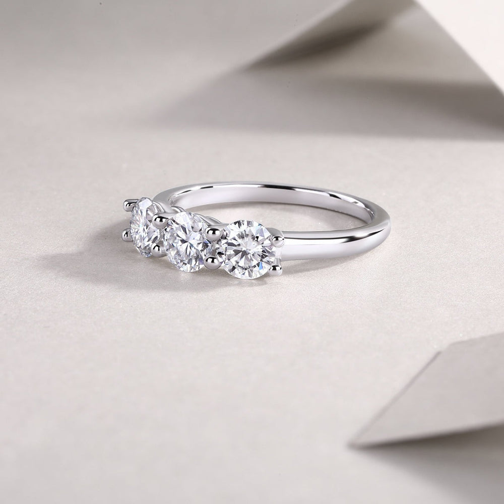 Side profile of three-stone moissanite ring in white gold vermeil with round stones