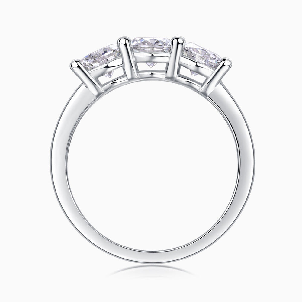 Top view of three-stone moissanite band showing prongs over round stones