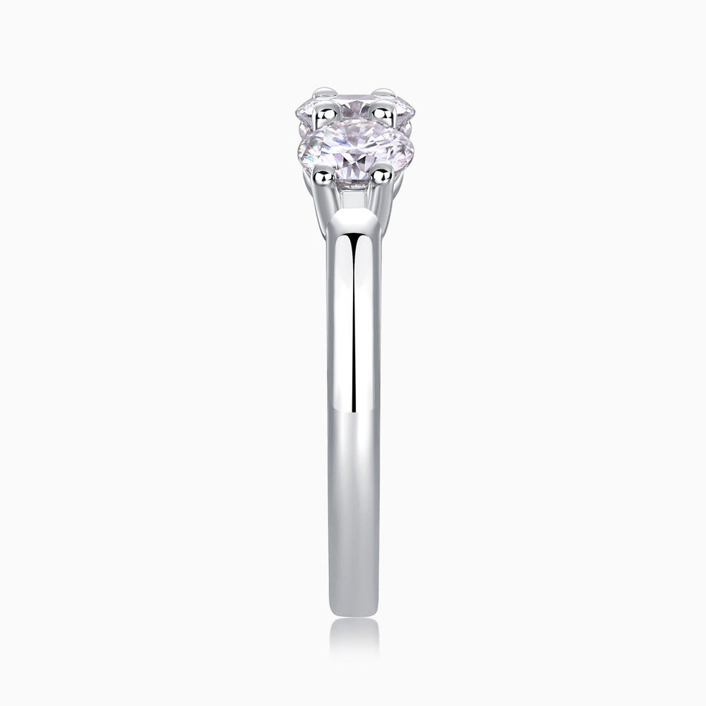 Three-stone moissanite ring with round center stone and matching side stones