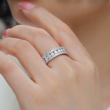 Pavé moissanite band with three rows of small round stones, close-up on hand, white metal